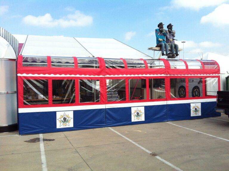 Red and blue tent with rooftop figures.