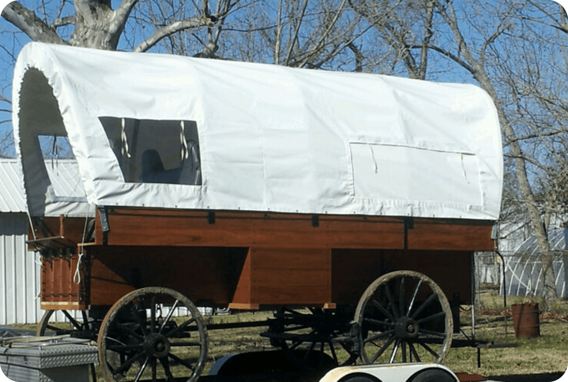 Covered wagon with white canvas top.